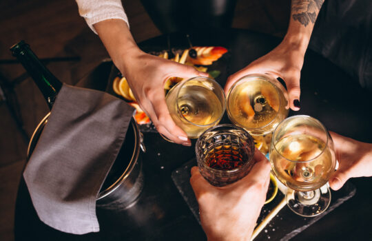 Male and female hands close up with cocktails