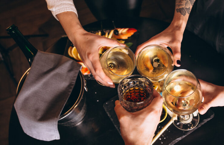 Male and female hands close up with cocktails